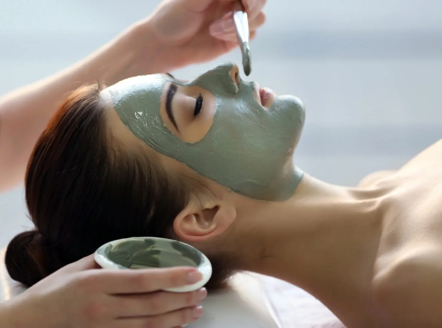 Spa,Concept.,Young,Woman,With,Nutrient,Facial,Mask,In,Beauty Spa concept. Young woman with nutrient facial mask in beauty salon, close up